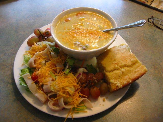 Today we have a lovely Chicken and Noodle Soup. Chicken, Artichoke, Mushroom and Onion Salad with a side of Grapes.  Generous portion of Ambrosia Cornbread.  Peach Iced Tea